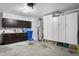 A spacious garage with cabinets, storage, and utility appliances including a water heater at 4240 Golf Club Ln, Tampa, FL 33618