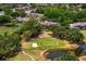 Aerial view of a well-manicured golf course next to residential properties surrounded by ponds and trees at 4240 Golf Club Ln, Tampa, FL 33618