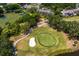 Aerial shot showcases the golf course with a sand trap, a pond, and lush foliage at 4240 Golf Club Ln, Tampa, FL 33618
