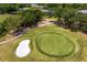 Lush green golf course with a sand bunker and mature trees surrounding the community homes at 4240 Golf Club Ln, Tampa, FL 33618