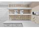 Modern kitchen features sleek white countertops, open shelving, and stylish backsplash at 4240 Golf Club Ln, Tampa, FL 33618