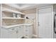 Kitchen area featuring white cabinets, modern shelving and quartz countertops at 4240 Golf Club Ln, Tampa, FL 33618