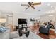 Inviting living room with a ceiling fan, wood floors, and an open view to the kitchen and dining area at 4240 Golf Club Ln, Tampa, FL 33618