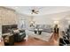 Cozy living room featuring a stone fireplace, hardwood floors, and a plush sofa at 4240 Golf Club Ln, Tampa, FL 33618