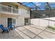 View of the outdoor patio with blue seating and an attached balcony at 4240 Golf Club Ln, Tampa, FL 33618