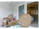 Cozy porch with rocking chairs opens to an airy bedroom with a view at 4240 Golf Club Ln, Tampa, FL 33618