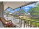 Relaxing screened porch overlooks a manicured backyard with golf course views at 4240 Golf Club Ln, Tampa, FL 33618