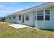 Backyard featuring a concrete patio, well-maintained lawn and light-colored siding at 4301 Avanti Cir, New Port Richey, FL 34655