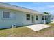 Backyard featuring a concrete patio, well-maintained lawn and light-colored siding at 4301 Avanti Cir, New Port Richey, FL 34655