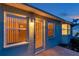 This side exterior shot of the home features a back door with a bay window and views into the warmly lit interior at 4301 Avanti Cir, New Port Richey, FL 34655