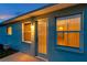 This side exterior shot of the home features a back door with a view into the warmly lit interior at 4301 Avanti Cir, New Port Richey, FL 34655