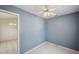 Bedroom view including ceiling fan, light blue walls and connecting room at 4301 Avanti Cir, New Port Richey, FL 34655