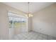 Cozy dining room featuring tile flooring and natural light from bay window at 4301 Avanti Cir, New Port Richey, FL 34655