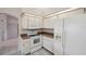 Bright kitchen features white appliances, cabinets and ample counter space at 4301 Avanti Cir, New Port Richey, FL 34655