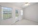 Bright living room with tile floors, ceiling fan, and sliding glass door to the backyard at 4301 Avanti Cir, New Port Richey, FL 34655