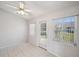 Bright living room with tile floors, ceiling fan, and sliding glass door to the backyard at 4301 Avanti Cir, New Port Richey, FL 34655