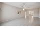 Open living area with tile flooring, ceiling fan, and neutral color palette at 4301 Avanti Cir, New Port Richey, FL 34655