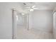 Open living room with tiled floors, ceiling fan, and large opening to another room at 4301 Avanti Cir, New Port Richey, FL 34655