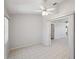Open living room with tiled floors, ceiling fan, and view to another room at 4301 Avanti Cir, New Port Richey, FL 34655