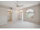 Spacious living room features tile flooring, ceiling fan, and natural light from a window at 4301 Avanti Cir, New Port Richey, FL 34655