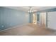 Main bedroom with carpet, ceiling fan, light, ensuite, and ample closet space at 4301 Avanti Cir, New Port Richey, FL 34655