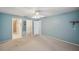 Main bedroom with carpet, ceiling fan, light, ensuite bathroom, and walk-in closet at 4301 Avanti Cir, New Port Richey, FL 34655