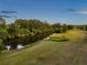Scenic river view with lush greenery and manicured lawn, offering a tranquil and picturesque setting at 4301 Avanti Cir, New Port Richey, FL 34655