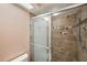 Shower includes glass doors and decorative tile at 4301 Avanti Cir, New Port Richey, FL 34655