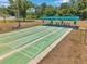 A full view of the community's shuffleboard courts under a covered shelter with benches at 4301 Avanti Cir, New Port Richey, FL 34655