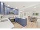 Open-concept kitchen with an island, stainless steel appliances, shaker cabinets and adjacent dining space at 4515 20Th N St, St Petersburg, FL 33714