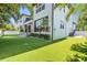 Wide backyard view with lush artificial turf and modern home architecture in the background at 481 W Davis Blvd, Tampa, FL 33606