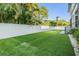 Large, green backyard with a white fence and well-maintained artificial turf at 481 W Davis Blvd, Tampa, FL 33606