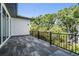 Large balcony with black railings, offering an outdoor space surrounded by lush greenery at 481 W Davis Blvd, Tampa, FL 33606