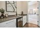 Entertaining bar area with wine fridge, glassware, and sink, adjacent to a bathroom at 481 W Davis Blvd, Tampa, FL 33606