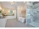 Luxurious bathroom with a soaking tub, glass shower, double vanity, and elegant lighting at 481 W Davis Blvd, Tampa, FL 33606