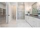 Bright bathroom with a walk-in shower, vanity, and an adjacent walk-in closet at 481 W Davis Blvd, Tampa, FL 33606