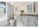 Cozy bathroom with modern vanity, framed mirror, and bathtub-shower combination with curtain at 481 W Davis Blvd, Tampa, FL 33606