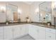 Elegant bathroom boasts double vanities with gray countertops, mirrors, and modern sconces at 481 W Davis Blvd, Tampa, FL 33606