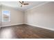 Inviting bedroom featuring hardwood floors, crown molding, a ceiling fan, and abundant natural light at 481 W Davis Blvd, Tampa, FL 33606