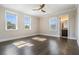 Bright bedroom featuring hardwood floors, a ceiling fan, and multiple windows at 481 W Davis Blvd, Tampa, FL 33606