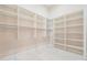 Walk-in closet with custom built-in shelving and hanging rods at 481 W Davis Blvd, Tampa, FL 33606