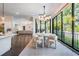Bright dining area featuring floor-to-ceiling windows, a modern chandelier, and elegant white chairs at 481 W Davis Blvd, Tampa, FL 33606