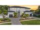 Stunning two-story home with lush landscaping, paver driveway, and a two-car garage, located at sunset at 481 W Davis Blvd, Tampa, FL 33606
