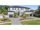 Beautiful two-story home with lush landscaping, paver driveway, and two-car garage at 481 W Davis Blvd, Tampa, FL 33606