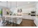 Modern, all-white kitchen with a large island, stainless steel appliances, and stylish pendant lighting at 481 W Davis Blvd, Tampa, FL 33606