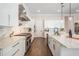 Bright kitchen with white cabinets, stainless steel appliances, and a marble backsplash at 481 W Davis Blvd, Tampa, FL 33606