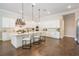 Open kitchen featuring a center island with chairs, modern appliances, and marble counters and backsplash at 481 W Davis Blvd, Tampa, FL 33606