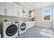 Modern laundry room featuring new washer and dryer and stylish patterned tile floor at 481 W Davis Blvd, Tampa, FL 33606