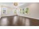 Bright living room with hardwood floors, large windows, and a modern chandelier at 481 W Davis Blvd, Tampa, FL 33606