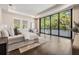 Bright main bedroom featuring hardwood floors, large windows, and lush outdoor views at 481 W Davis Blvd, Tampa, FL 33606